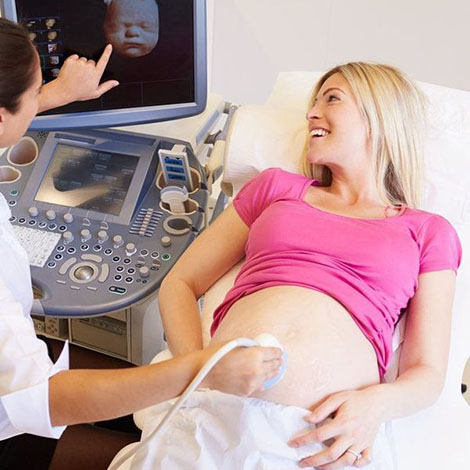 A pregnant woman undergoing an ultrasound